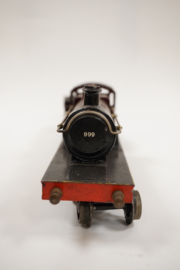 An 0 gauge Bing clockwork tinplate Midland Railway 4-4-0 tender locomotive, 999, in maroon livery with yellow and black lining and original clockwork mechanism